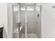 The tile shower features a glass enclosure, bench, and built-in shampoo niche at 10426 Cross River Trl, Parrish, FL 34219
