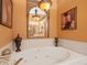 A jacuzzi tub with tile surround and decorative fixtures at 1109 Pinellas Bayway S # 306, Tierra Verde, FL 33715