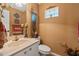 Elegant powder room featuring a marble vanity, decorative art, and a charming glass block window at 1109 Pinellas Bayway S # 306, Tierra Verde, FL 33715