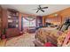 A large bedroom with a ceiling fan, rug and wooden furniture at 1109 Pinellas Bayway S # 306, Tierra Verde, FL 33715