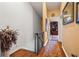 Hallway leading to a room with a bookcase and a decorative rug at 1109 Pinellas Bayway S # 306, Tierra Verde, FL 33715