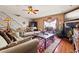 Inviting living room with wood floors, a fireplace, comfortable sofas, and tasteful decor create a cozy atmosphere at 1109 Pinellas Bayway S # 306, Tierra Verde, FL 33715