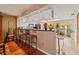 Open-concept space with breakfast bar overlooking the kitchen, hardwood floors, and natural light enhances its charm at 1109 Pinellas Bayway S # 306, Tierra Verde, FL 33715