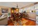 Inviting living space with hardwood floors, dining area, and breakfast bar, creating a warm and welcoming atmosphere at 1109 Pinellas Bayway S # 306, Tierra Verde, FL 33715