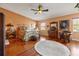 Spacious primary bedroom with hardwood floors, a ceiling fan, and ornate furnishings at 1109 Pinellas Bayway S # 306, Tierra Verde, FL 33715