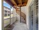 Enclosed patio featuring a unique spiral staircase leading to an upper level with screened windows and access to the outdoors at 1109 Pinellas Bayway S # 306, Tierra Verde, FL 33715