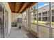 Enclosed outdoor patio featuring a wooden ceiling, AC unit, and screened windows, offering a comfortable and private retreat at 1109 Pinellas Bayway S # 306, Tierra Verde, FL 33715