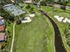 Overhead view of golf course and landscaping featuring water features, sand traps, and walking paths at 1115 Ashbourne Cir, Trinity, FL 34655