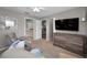 Bedroom with a mirror, ceiling fan, tv set up, a dresser, and a gray, reclining chair at 1115 Ashbourne Cir, Trinity, FL 34655