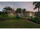 Inviting front exterior featuring lush landscaping, charming walkway, and a warm, welcoming ambiance at 1115 Ashbourne Cir, Trinity, FL 34655