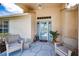 Charming front porch with cozy seating, offering a welcoming entrance to the home at 1115 Ashbourne Cir, Trinity, FL 34655