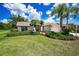 Well-maintained home featuring a lush lawn, complemented by mature landscaping and inviting walkway to the front door at 1115 Ashbourne Cir, Trinity, FL 34655