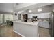 Bright kitchen features white cabinets, stainless steel appliances, and breakfast bar at 1115 Ashbourne Cir, Trinity, FL 34655
