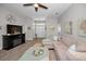 Warm living room featuring tile floors, a decorative fireplace, and cozy seating arrangement at 1115 Ashbourne Cir, Trinity, FL 34655