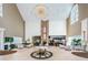 Spacious lobby featuring high ceilings, fireplace, piano, seating areas, and abundant natural light for a luxurious experience at 1115 Ashbourne Cir, Trinity, FL 34655