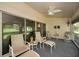 Sunroom featuring four lounge chairs, lots of sun, and a ceiling fan to keep cool at 1115 Ashbourne Cir, Trinity, FL 34655