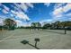 A well-maintained tennis court with good lighting and nets in place at 1115 Ashbourne Cir, Trinity, FL 34655