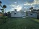 Backyard with well-maintained lawn and two storage sheds; a serene and spacious outdoor retreat at 12009 Washington St, Seffner, FL 33584