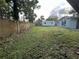 Large grassy backyard featuring a shed and partial fencing at 12009 Washington St, Seffner, FL 33584