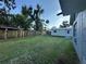 Large grassy backyard featuring a shed and partial fencing at 12009 Washington St, Seffner, FL 33584