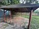 Rustic gazebo with a brown roof and a stone paver floor sits nestled in the spacious backyard of this beautiful home at 12009 Washington St, Seffner, FL 33584