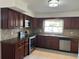 Well-equipped kitchen featuring stainless steel appliances and dark wood cabinetry at 12009 Washington St, Seffner, FL 33584