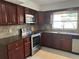 The kitchen offers stainless steel appliances, beautiful dark cabinetry, and natural light at 12009 Washington St, Seffner, FL 33584
