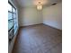 Bright living room with tiled floors, large windows, and a chandelier, offering a clean and inviting space at 12009 Washington St, Seffner, FL 33584
