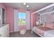 A cheerful pink bedroom with floral wallpaper, white furniture, plush accents, and a bright window view at 12824 Wanderlust Pl, Parrish, FL 34219