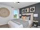 Inviting bedroom with stylish decor, a queen-size bed, and a scenic window view at 12824 Wanderlust Pl, Parrish, FL 34219