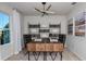 Home office with a large desk, comfortable chairs, and ample shelving space at 12824 Wanderlust Pl, Parrish, FL 34219