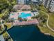 An aerial view of a community pool, spa, and lake access with boat docks at 1324 Pasadena S Ave # 501, South Pasadena, FL 33707