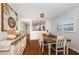 Inviting dining room with natural light, a modern light fixture and hardwood floors at 1324 Pasadena S Ave # 501, South Pasadena, FL 33707