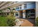 Building entrance and landscaping, including a small palm tree and stone at 1324 Pasadena S Ave # 501, South Pasadena, FL 33707