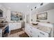 Bright kitchen featuring marble countertops, white cabinets, and stainless steel appliances at 1324 Pasadena S Ave # 501, South Pasadena, FL 33707