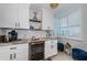 Charming kitchen showcasing white cabinets, marble countertops and a wine refrigerator at 1324 Pasadena S Ave # 501, South Pasadena, FL 33707