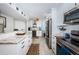 Stylish kitchen featuring stainless steel appliances, marble countertops, and a wine fridge at 1324 Pasadena S Ave # 501, South Pasadena, FL 33707