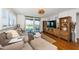 Bright living room featuring balcony access with waterfront views and a comfortable couch at 1324 Pasadena S Ave # 501, South Pasadena, FL 33707