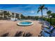 Community spa and lounge area with plentiful seating surrounding the pool at 1324 Pasadena S Ave # 501, South Pasadena, FL 33707