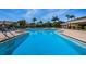 Community pool with outdoor lounge chairs and plentiful seating at 1324 Pasadena S Ave # 501, South Pasadena, FL 33707