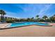 Community pool with outdoor lounge chairs perfect for relaxing in the sun at 1324 Pasadena S Ave # 501, South Pasadena, FL 33707