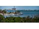 Picturesque water view featuring palm trees and waterfront buildings on a clear day at 1324 Pasadena S Ave # 501, South Pasadena, FL 33707