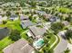 Lovely aerial view of a home with a private pool, lush landscaping, and a neighborhood setting at 13728 Artesa Bell Dr, Riverview, FL 33579