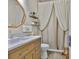 Stylish bathroom with wooden vanity, marble countertop and modern fixtures at 13728 Artesa Bell Dr, Riverview, FL 33579
