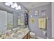 Charming bathroom featuring gray walls, decorative wall art, a granite vanity, and a framed mirror at 13728 Artesa Bell Dr, Riverview, FL 33579