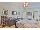 Bedroom with an attached bathroom, neutral walls, and a ceiling fan at 13728 Artesa Bell Dr, Riverview, FL 33579