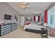 Cozy bedroom featuring gray walls, carpet flooring, a ceiling fan, and a comfortable bed with a red throw at 13728 Artesa Bell Dr, Riverview, FL 33579