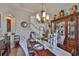 Dining room featuring a wood table set for six, chandelier, and curio cabinet at 13728 Artesa Bell Dr, Riverview, FL 33579