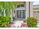 Charming home entrance with a decorative door and lush landscaping at 13728 Artesa Bell Dr, Riverview, FL 33579