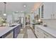 Kitchen with stainless appliances, white cabinets, and view to dining room at 13728 Artesa Bell Dr, Riverview, FL 33579